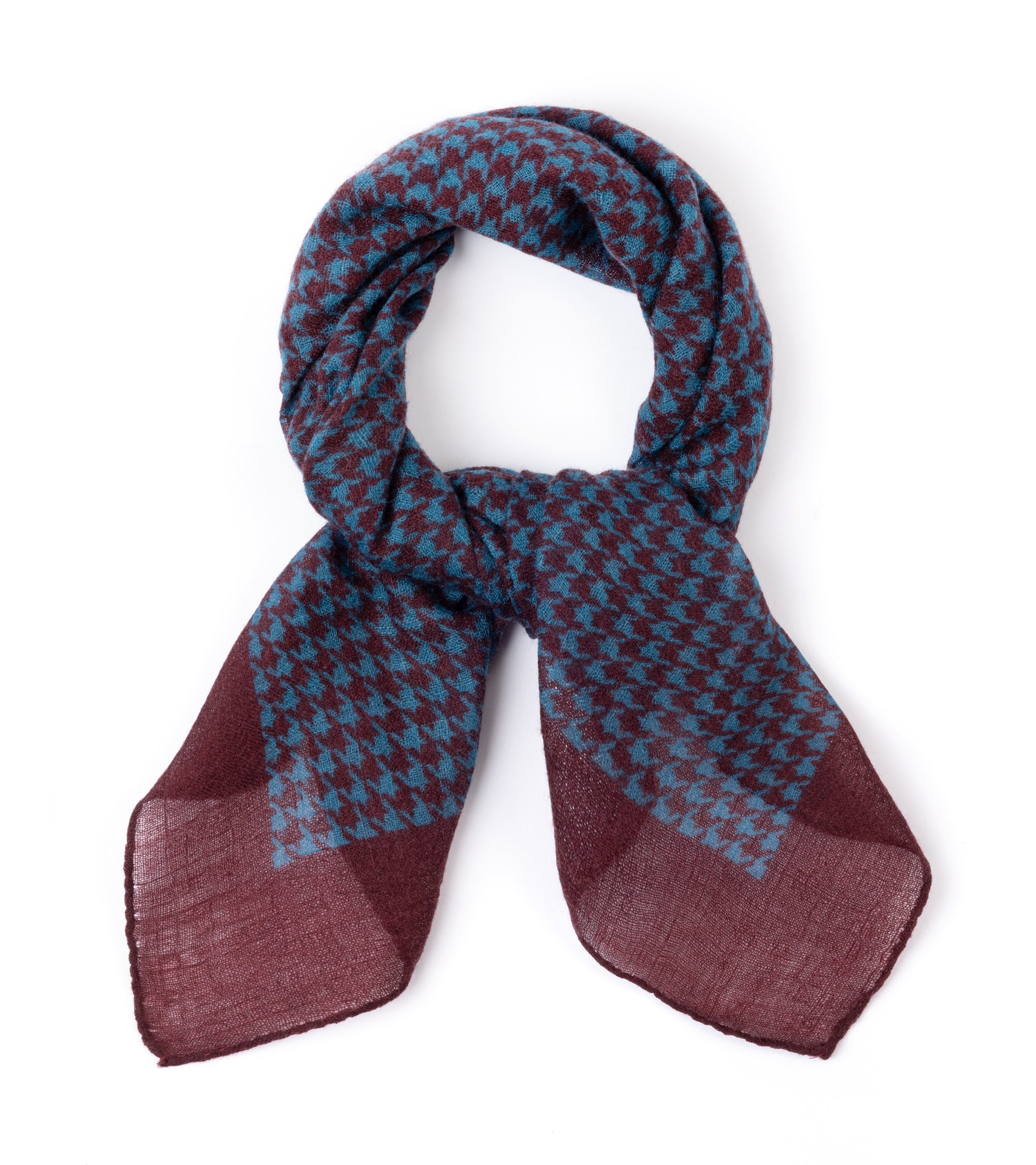 A blue and burgundy houndstooth scarf, styled in a loop on a plain white background.