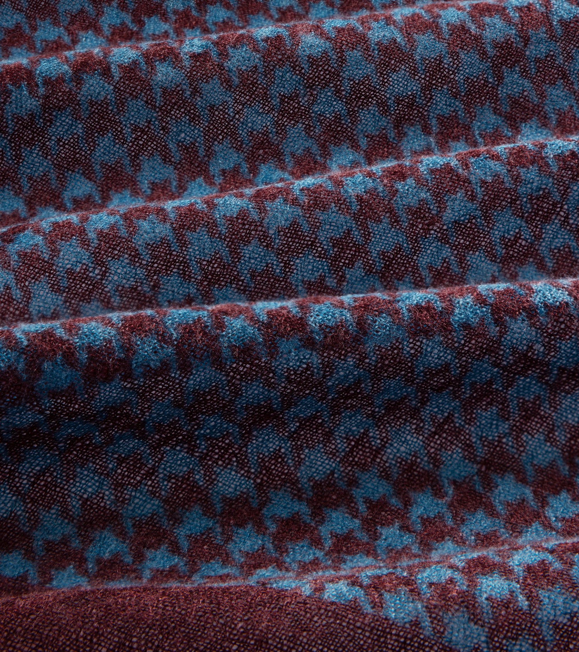 Close-up of the bandana houndstooth pattern in burgundy and blue.