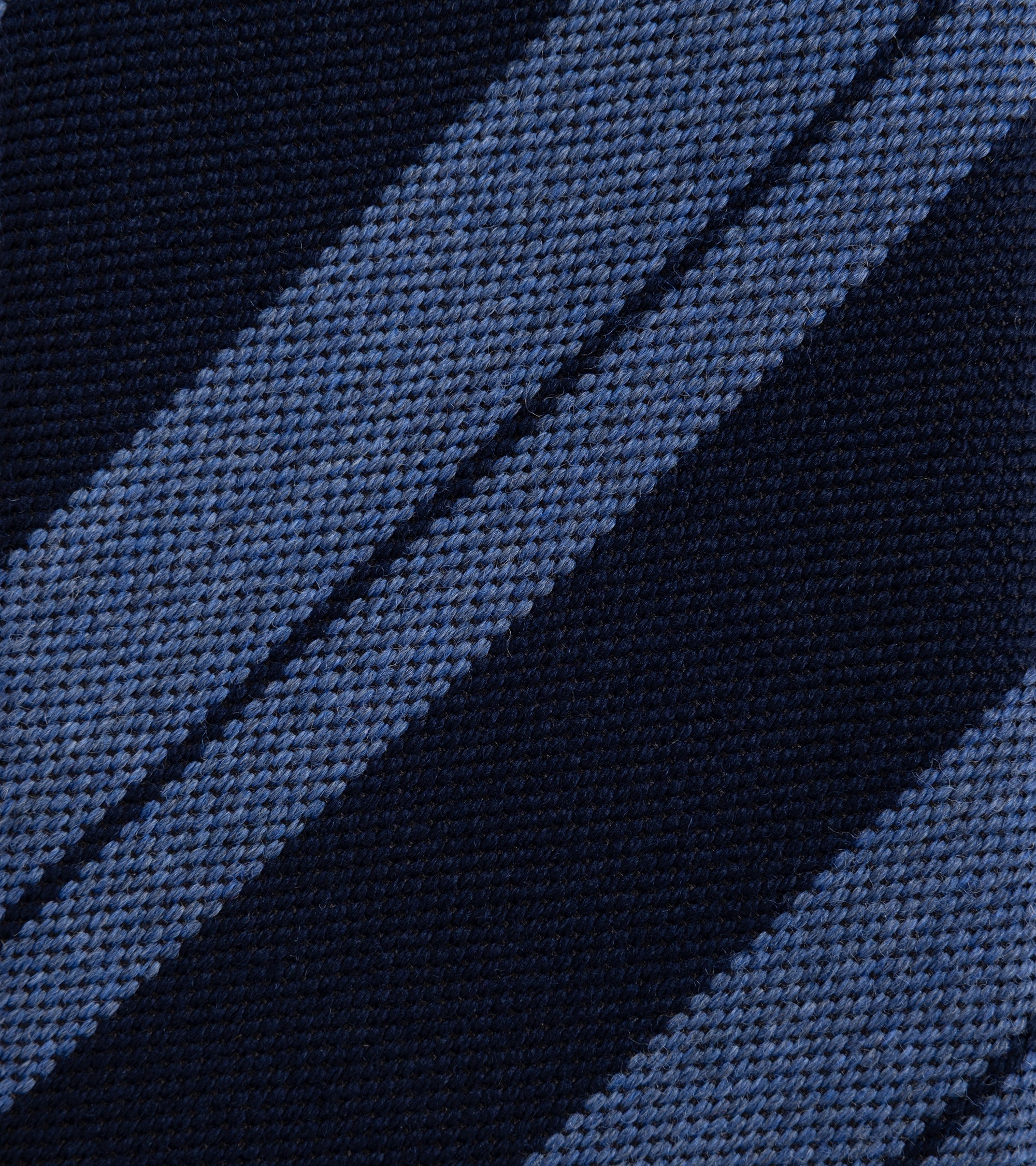 Close-up of a woven fabric with diagonal stripes in navy and blue.