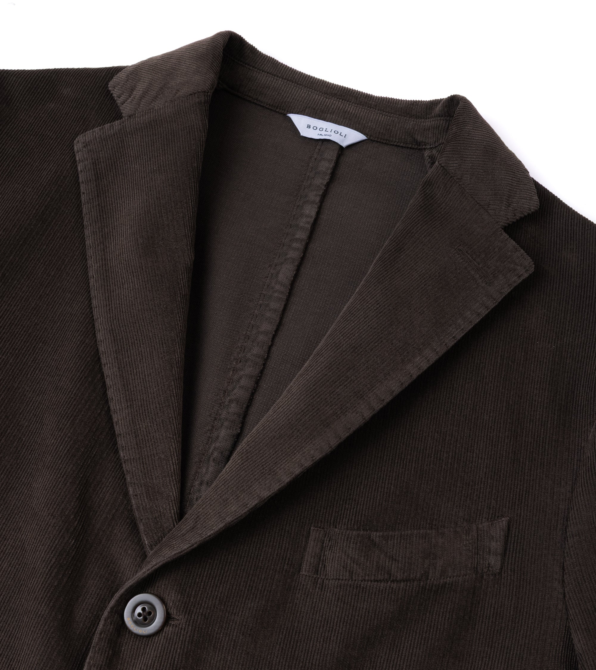 Close-up of a dark brown corduroy blazer jacket showing the collar, button, and chest pocket against a white background.