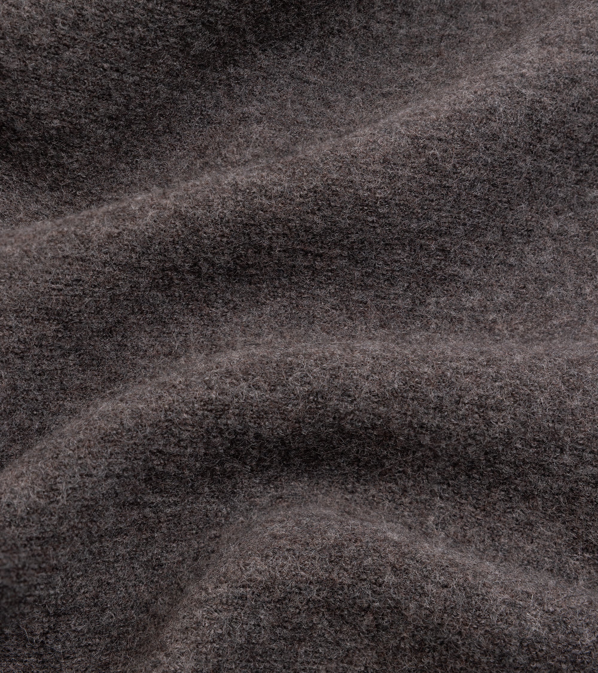A close-up of dark navy blue textured fabric.