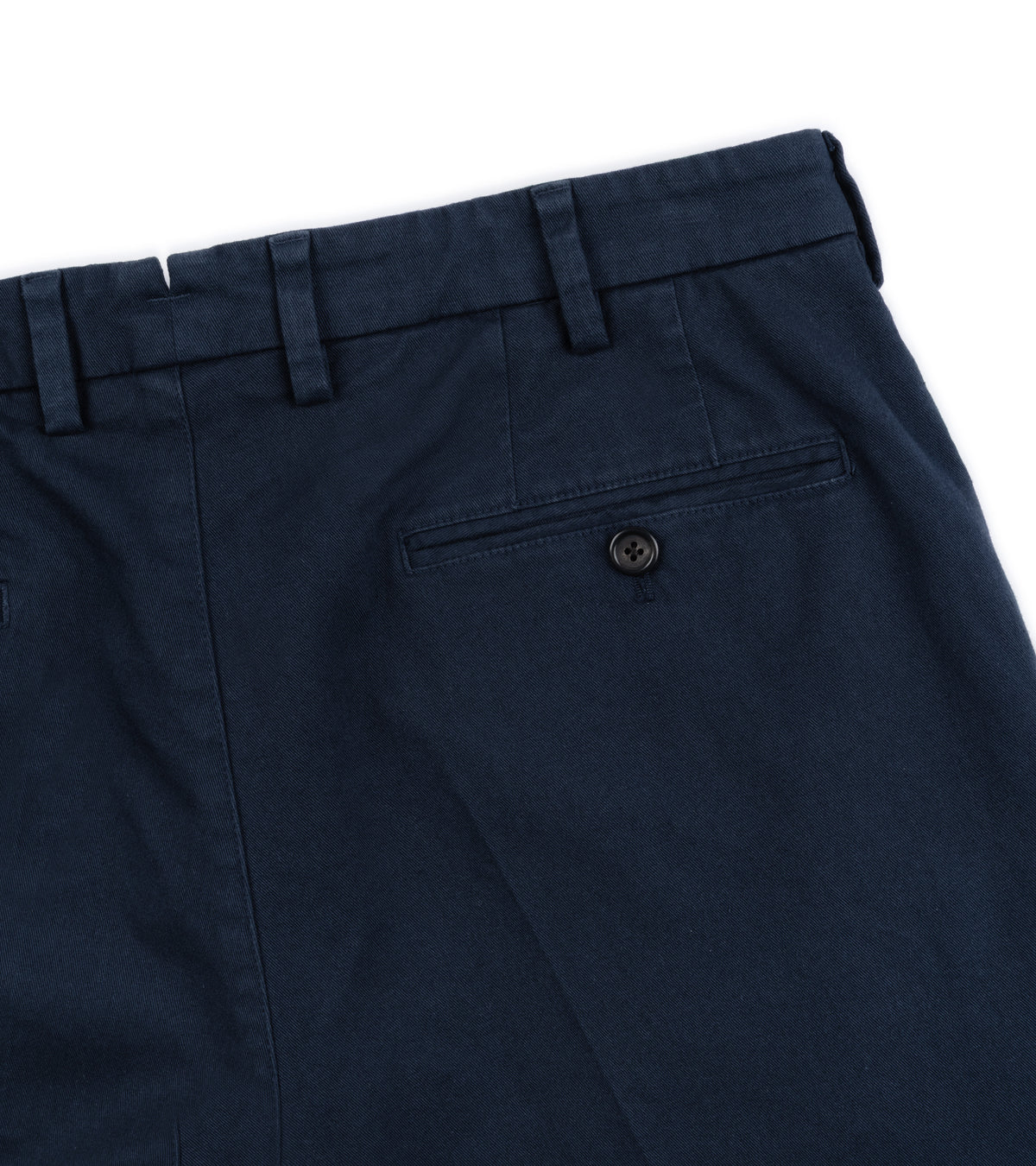 Back close-up of the Trunk Palmer Flat Front Cotton Twill Trousers in Navy showing the waistband, belt loops, a rear welt pocket with a button.