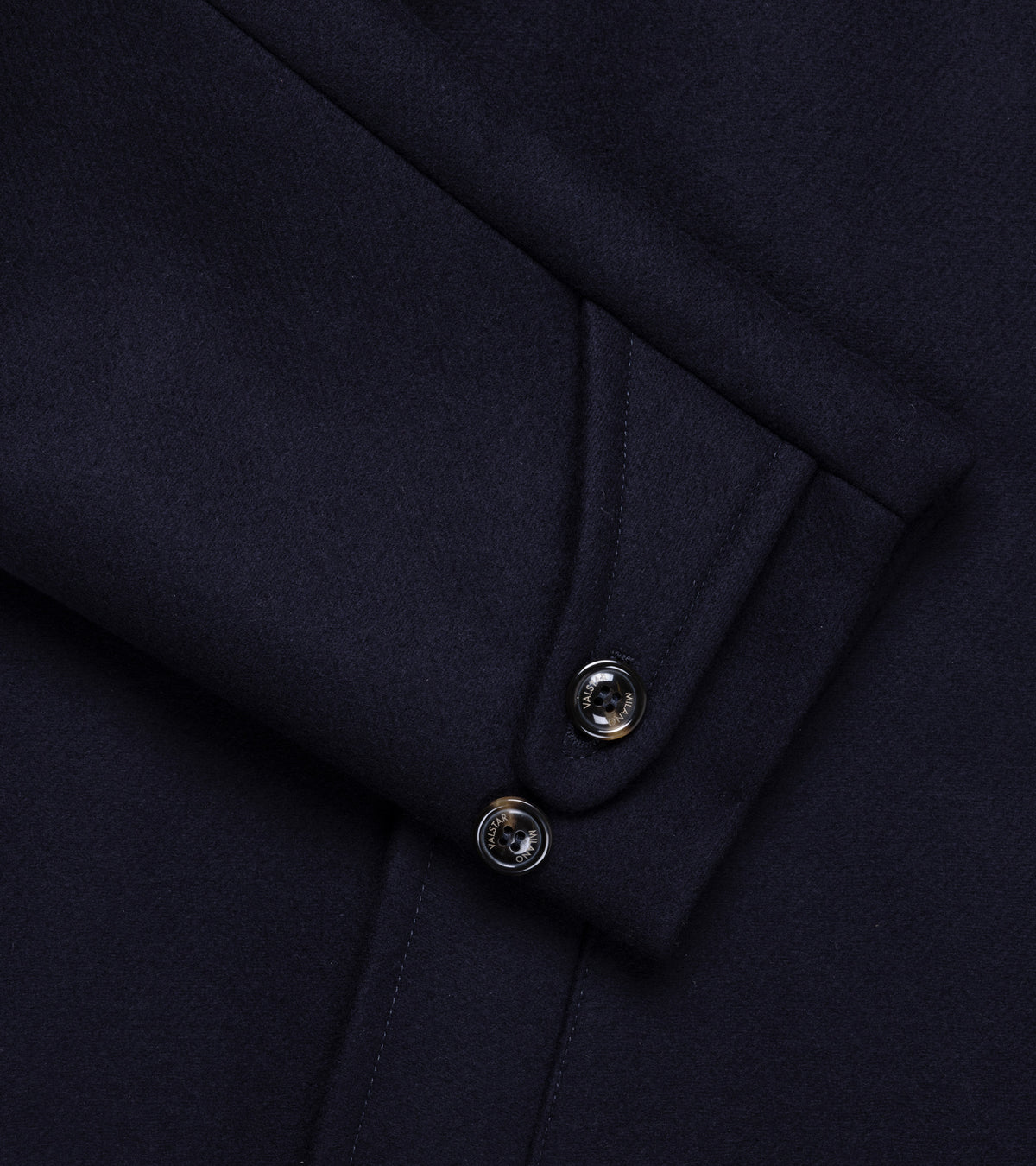 Valstar Vittorio Wool Felt Raglan Overcoat in Navy. Close-up detail of the button-tab cuff on the sleeve and pocket.