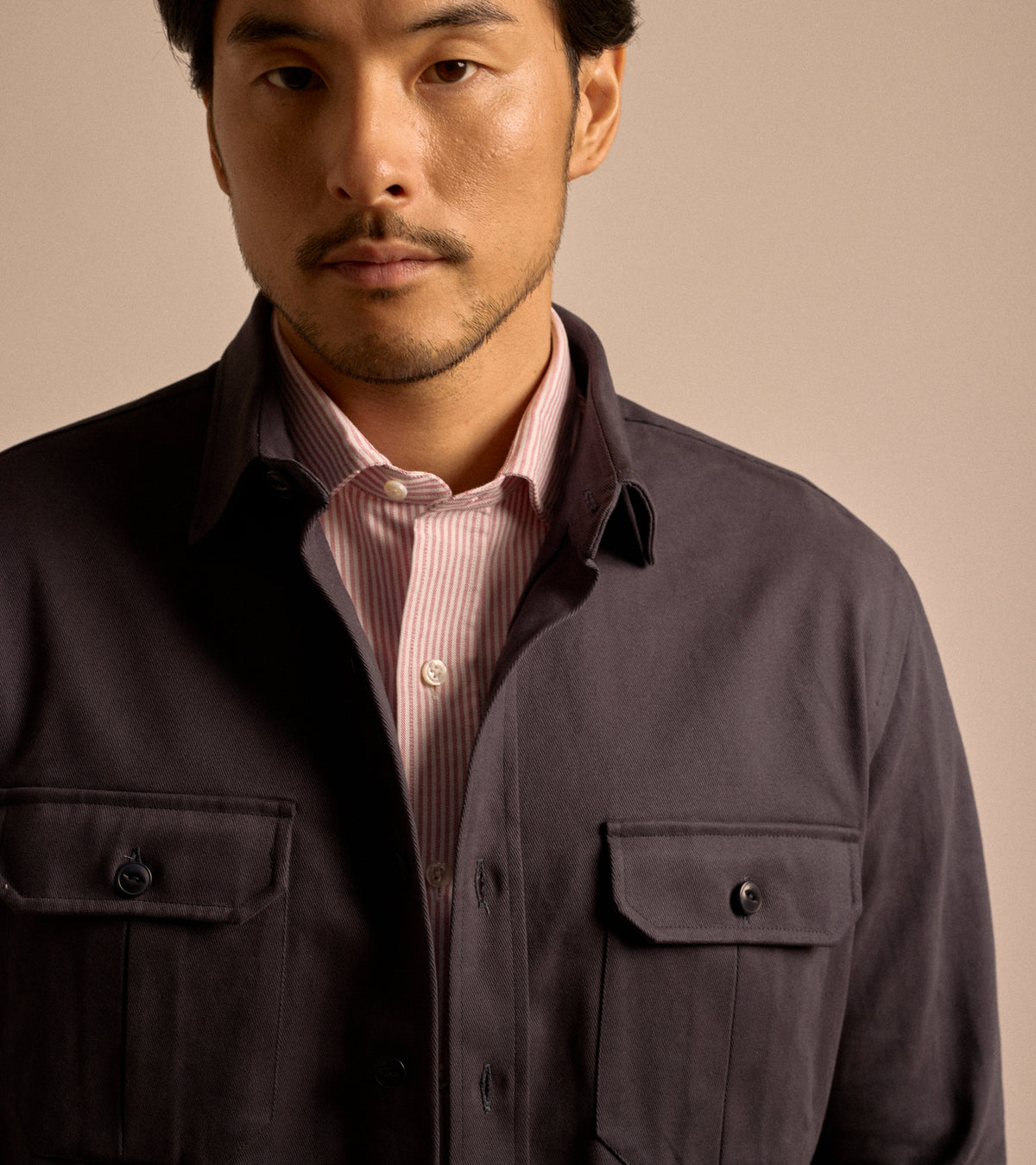 Model wearing the Salvatore Piccolo Cotton Twill Military Shirt in navy, styled with a Salvatore Piccolo shirt in red and white stripe. Close-up detail of the collar.