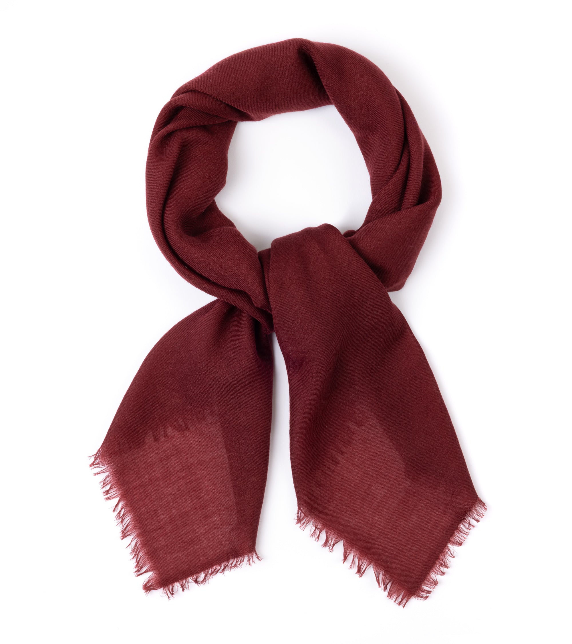 A deep burgundy scarf with fringed edges, styled in a looped knot on a clean white background.