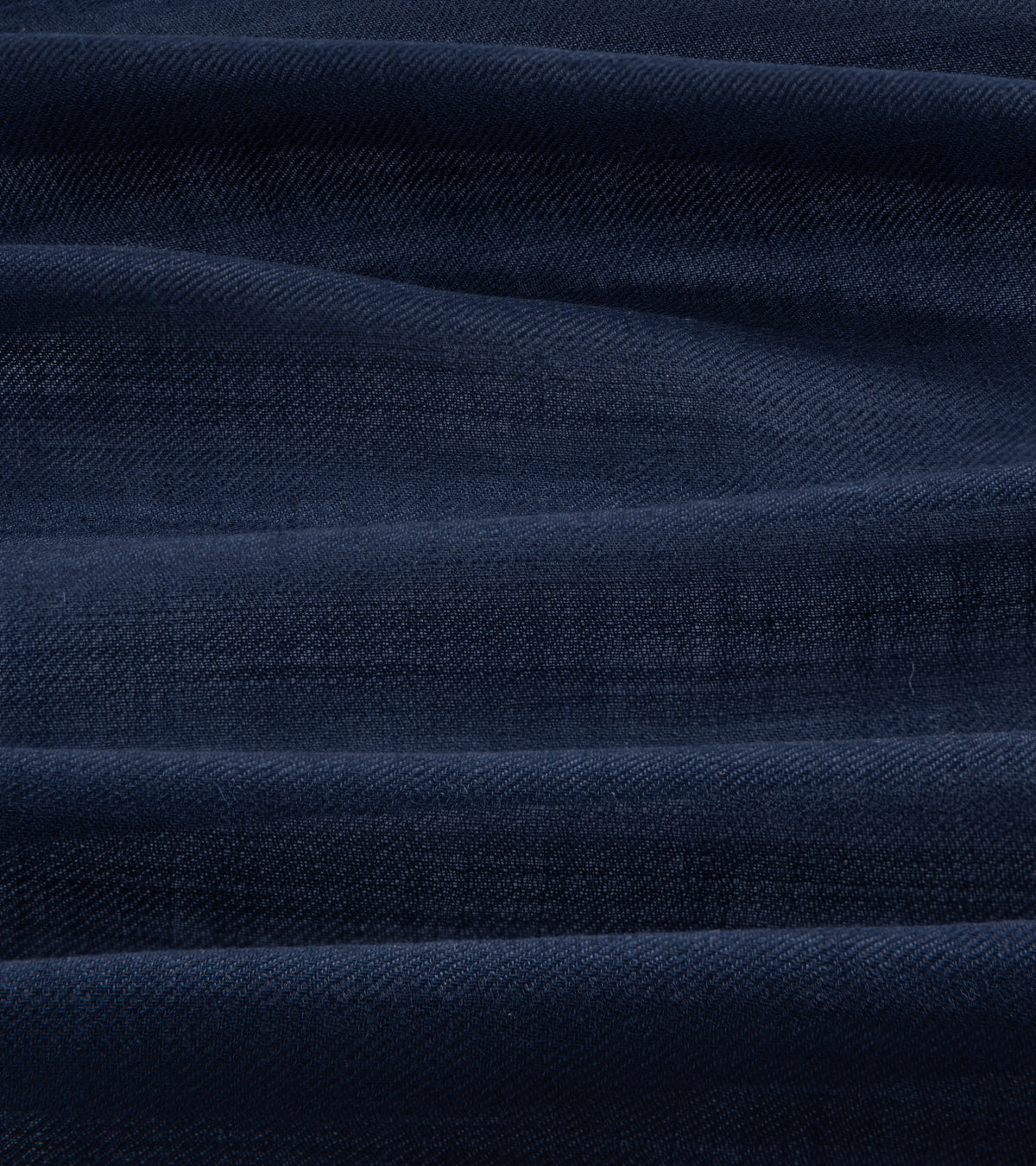 A close-up of dark navy blue textured fabric.