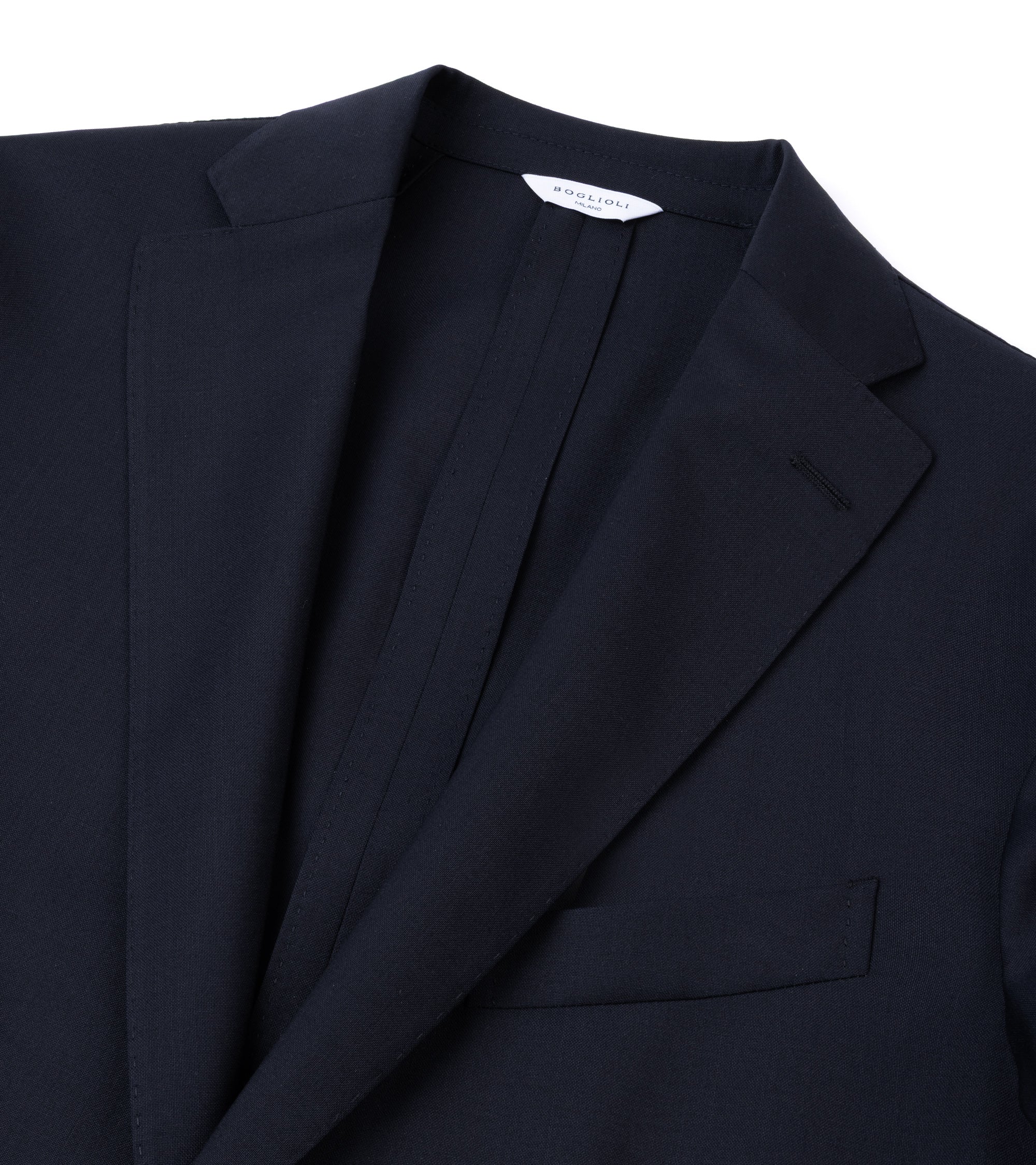 Close-up of a navy blue blazer jacket showing the collar and chest pocket against a white background.