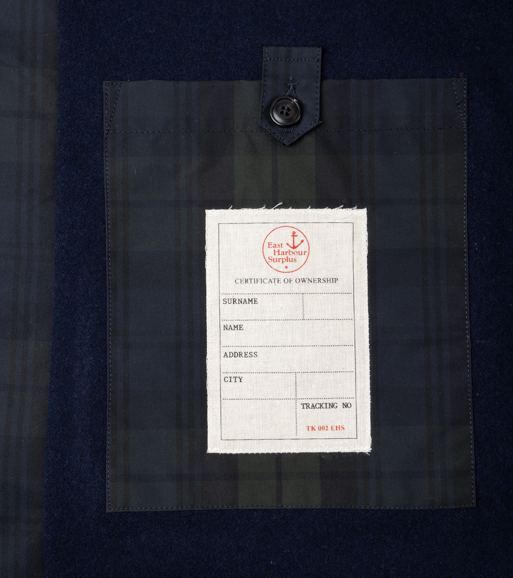 Close-up detail of the inner pocket with button closure and label.