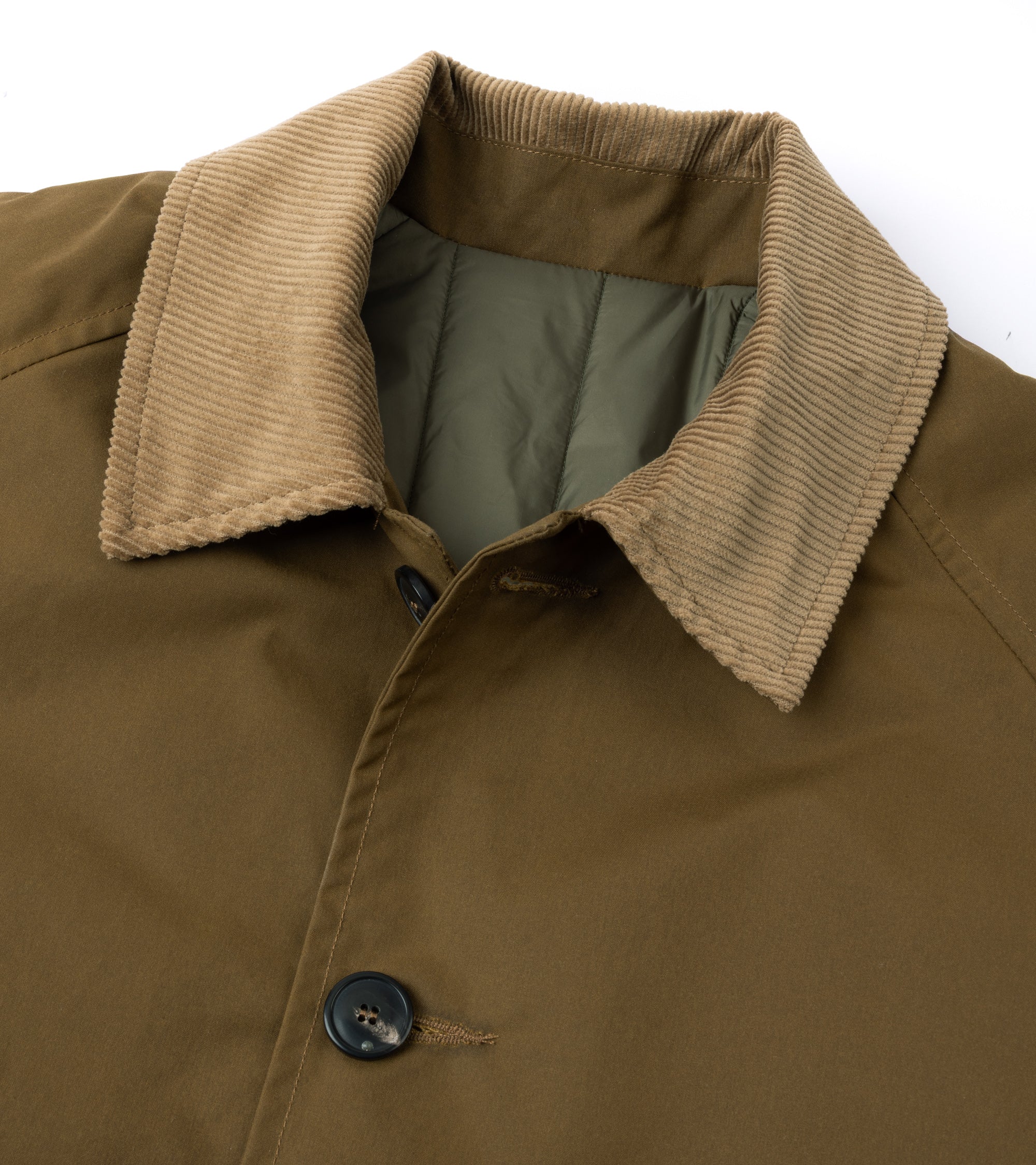 Close-up of a corduroy collar and front placket of a jacket, showing a dark button and olive green inner lining against a white background.