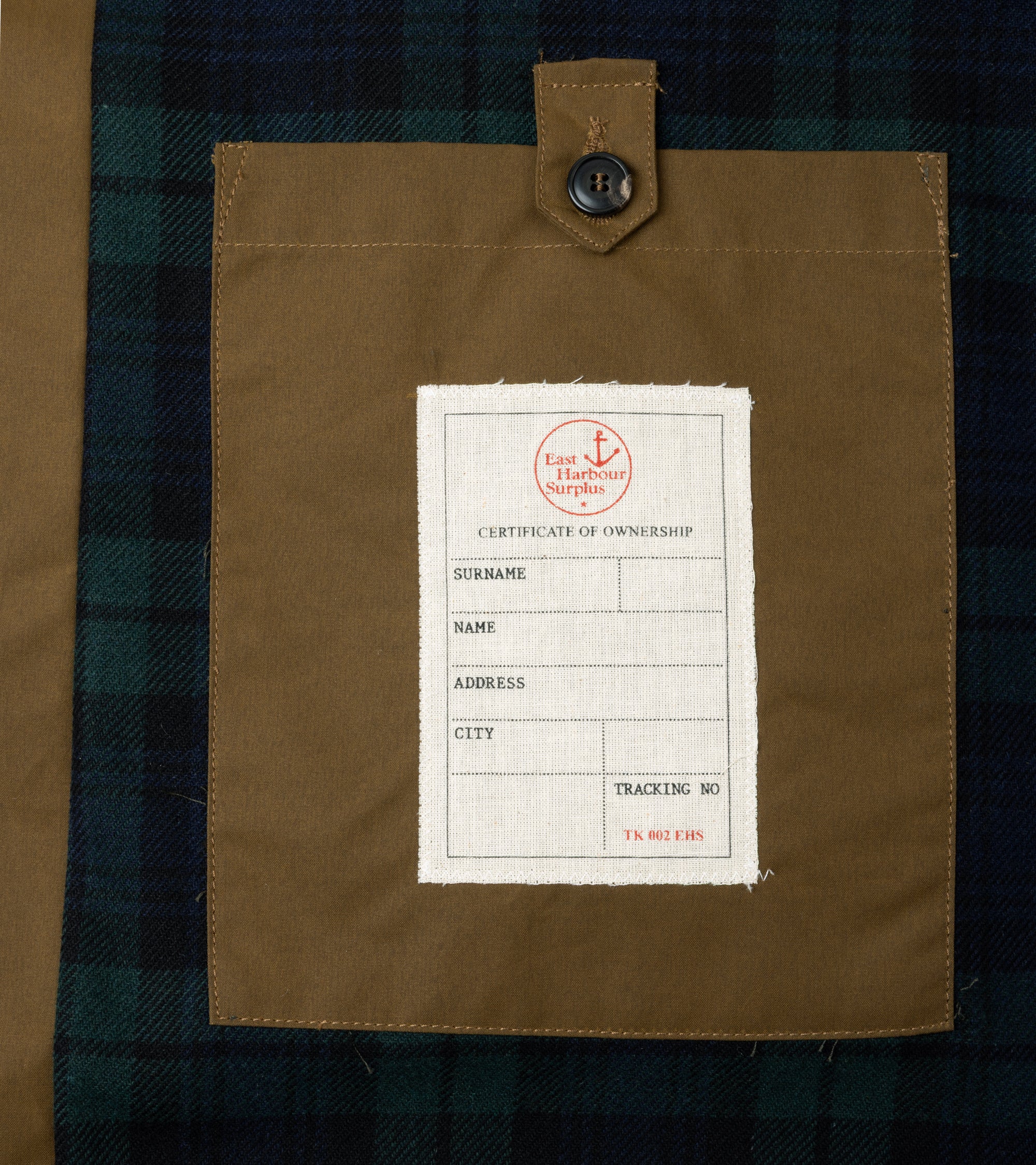 Close-up detail of the inner pocket with button closure and label.