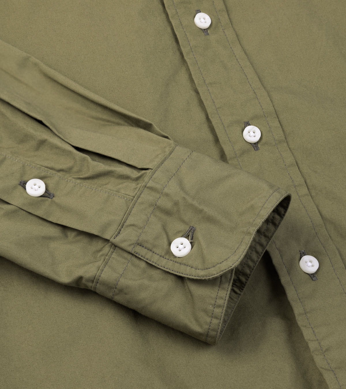 Close-up of the Gitman Vintage Japanese Cotton Twill Button Down Shirt in Olive showing the buttoned cuff and fabric texture.