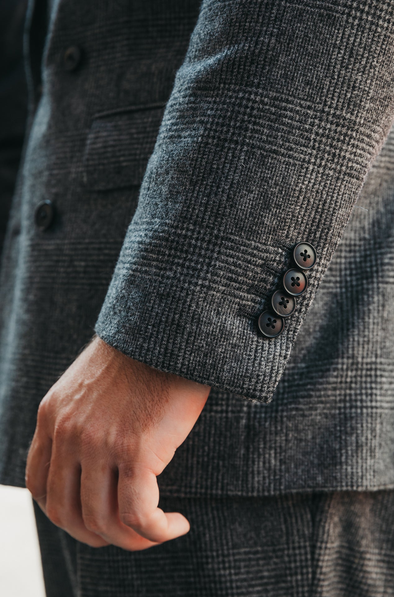 Close-up of a gray textured suit with buttons